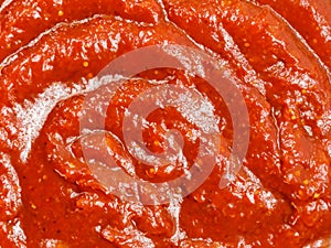 ketchup sauce in a white plate. top view