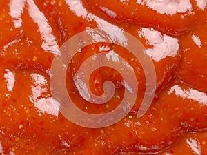 ketchup sauce in a white plate. top view