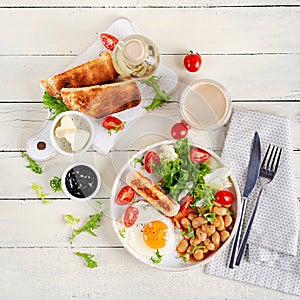 Keto breakfast. Fried egg, beans, chicken sausage and coffee cup. Top view, flat lay