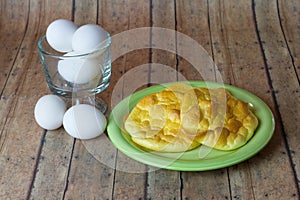 Keto Egg Bread on a wood plank board with a bowl of eggs