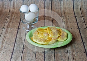 Keto Egg Bread on a wood plank board with a bowl of eggs