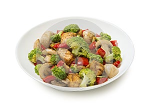 Keto low carb chicken stir fry with bell peppers, mushrooms, ginger and broccoli in a salad bowl isolated on white background.