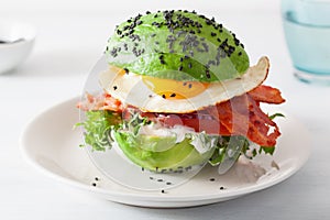 Keto paleo diet avocado breakfast burger with bacon, egg, tomato