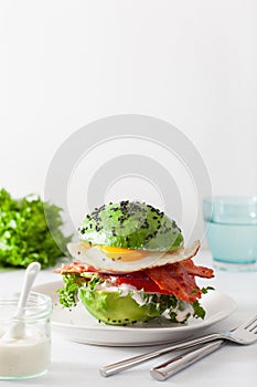 Keto paleo diet avocado breakfast burger with bacon, egg, tomato