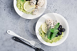 Keto paleo diet lunch, mashed broccoli with butter, meat balls in sour cream sauce, spinach, cucumber, olives. Low