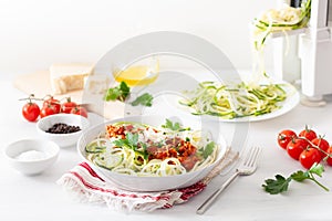 Keto paleo zoodles bolognese: zucchini noodles with meat sauce and parmesan