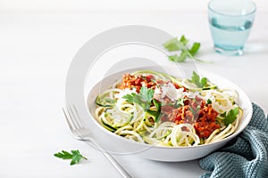 Keto paleo zoodles bolognese: zucchini noodles with meat sauce and parmesan