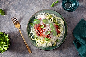 Keto paleo zoodles bolognese: zucchini noodles with meat sauce and parmesan