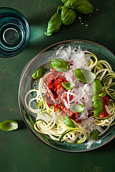 Keto paleo zoodles bolognese: zucchini noodles with meat sauce and parmesan