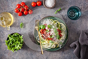 Keto paleo zoodles bolognese: zucchini noodles with meat sauce and parmesan