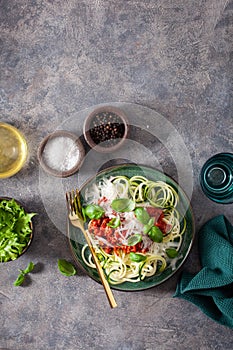 Keto paleo zoodles bolognese: zucchini noodles with meat sauce and parmesan