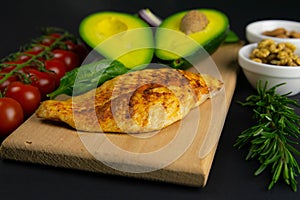 Ketogenic diet concept. A set of products of the low carb keto diet. Green vegetables, nuts, chicken fillet, flax seeds