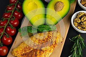 Ketogenic diet concept. A set of products of the low carb keto diet. Green vegetables, nuts, chicken fillet, flax seeds