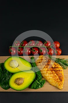 Ketogenic diet concept. A set of products of the low carb keto diet. Green vegetables, nuts, chicken fillet, flax seeds