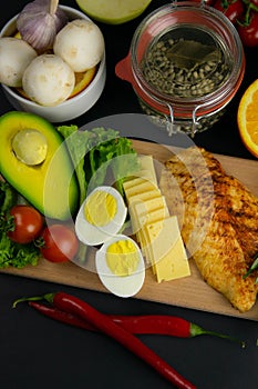 Ketogenic diet concept. A set of products of the low carb keto diet. Green vegetables, nuts, chicken fillet, flax seeds