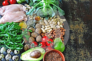 Ketogenic diet concept. A set of products of the low carb keto diet. Green vegetables, nuts, chicken fillet, flax seeds, quail egg