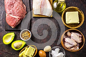 Ketogenic diet food. Balanced low-carb food background. Fish, meat, cheese, nuts on a dark background. Healthy balanced food with