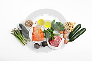 Ketogenic, keto diet, including vegetables, meat and fish, nuts and oil on white background photo