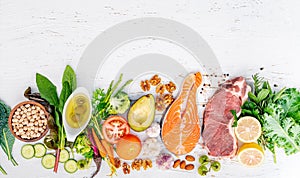 Ketogenic low carbs diet concept. Ingredients for healthy foods selection on white wooden background. Balanced healthy ingredients