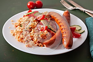 Ketogenic paleo diet lunch. cauliflower rice and grilled sausages