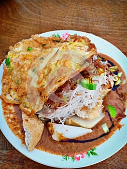 Ketoprak is a typical Indonesian food. Which contains rice cake, vermicelli, cucumber, fried egg, and doused with peanut sauce