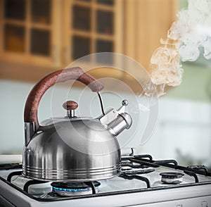 Kettle boiling on a gas stove in the kitchen