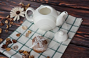 Kettle and cookies on wooden background