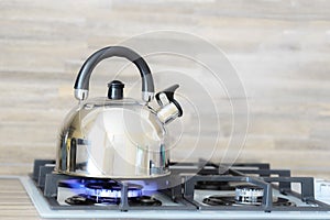 Kettle on a gas stove flame burn not boiling photo