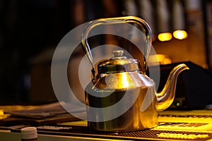 Kettle kept under yellow light on table in punter house cafe Delhi dwarka photo