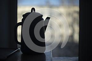 Kettle in kitchen. Water kettle. Darkens indoors