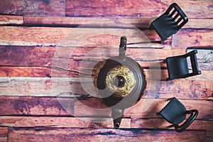 Clay teapot with tea on a wooden table photo