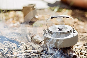 Kettle with water standing on the coals