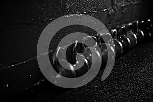 Kettlebells on the floor in a crossfit gym B/W