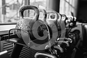 Kettlebells in a rack at the gym. Free weights close up.