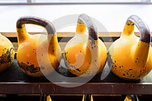 Kettlebells in a rack at the gym. Free weights close up.