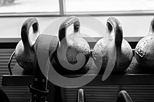 Kettlebells in a rack at the gym. Free weights close up.