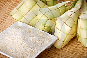 Ketupat rice dumpling and rice on traditional woven tray