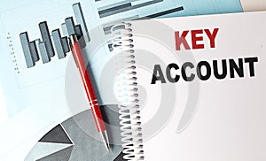 KEY ACCOUNT text on a notebook with pen on a chart background