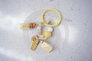 Key chain bag charm on greyish white background. Top view