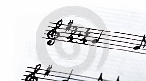 Key, double time signature symbol and violin clef. Musical notation macro, closeup. Single line sheet music detail example