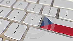 Key with flag of the Czech Republic on the computer keyboard switches to key with flag of China, translation or