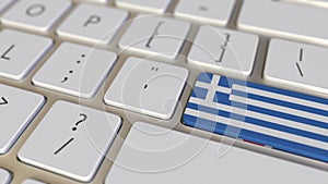 Key with flag of Greece on the computer keyboard switches to key with flag of Great Britain, translation or relocation
