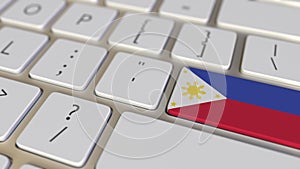 Key with flag of Philippines on the computer keyboard switches to key with flag of the USA, translation or relocation