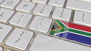 Key with flag of South Africa on the computer keyboard switches to key with flag of Great Britain, translation or