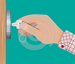 Key in hand opens wooden door.