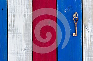 Key hanging on colorful wood old weathered door