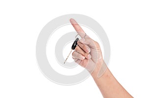 Key hanging on finger white background isolated