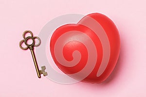 Key and heart on a pink background. Relationship Theme