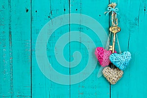 Key and hearts hanging on wood door