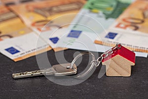 Key with house shaped key chain with euro banknotes